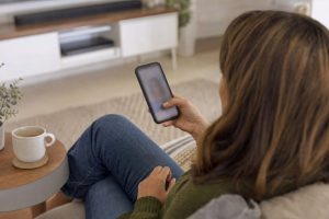 Homeowner searching for a local business on her phone